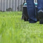10283098-man-mowing-lawn-in-his-garden-in-summer